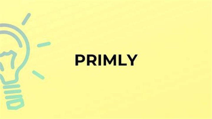 Does the word primly mean?
