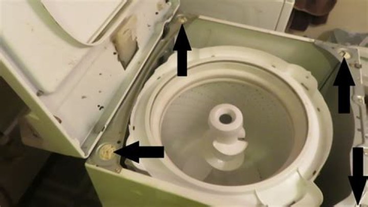 During the spin cycle of a washing machine the clothes?