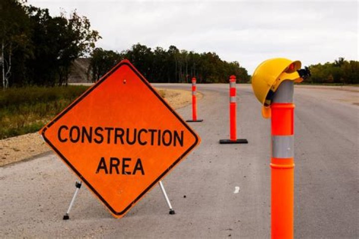 When passing a construction zone you should?