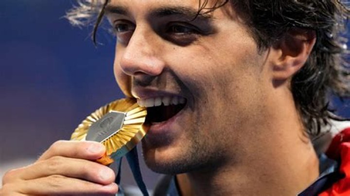 Why do winners bite their medals?