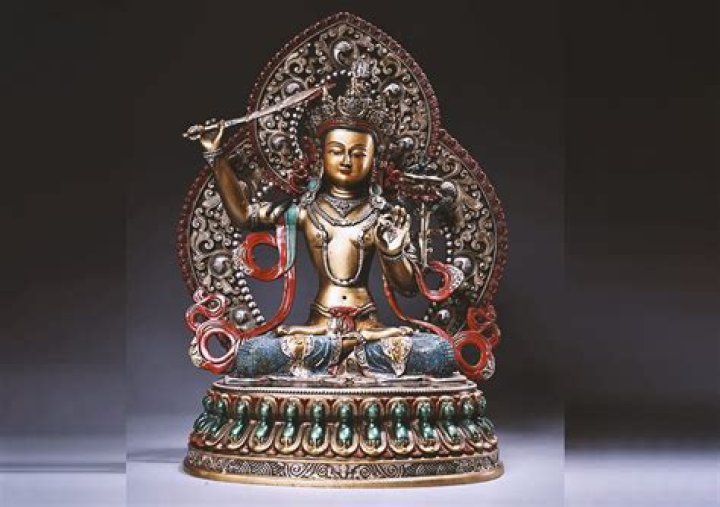 Why is manjushri holding a sword?